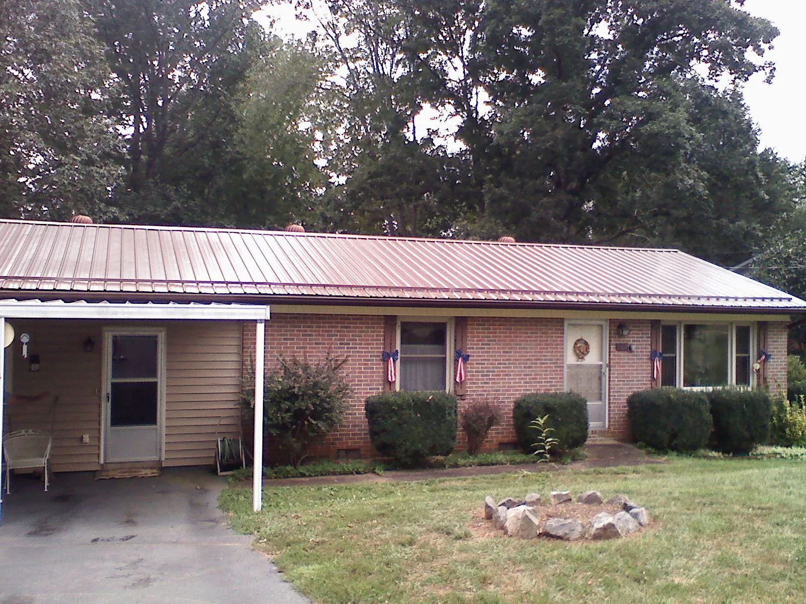 Bronze metal roof and carport on a brick ranch home — Roof Repair work by our crew in Tangent